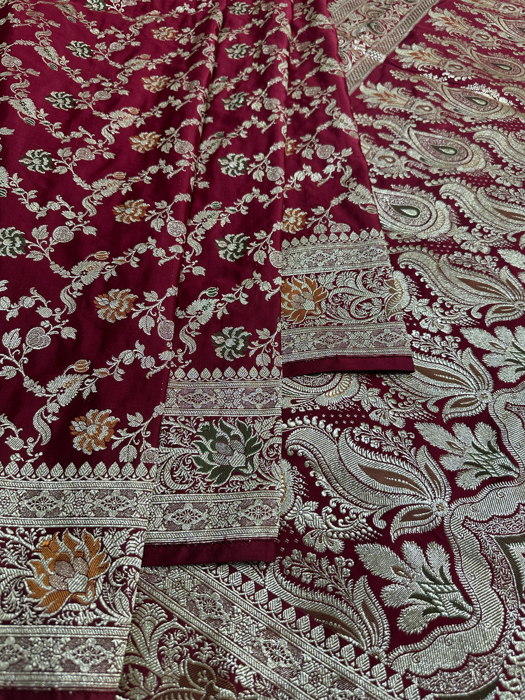 Beautifully draped maroon Banarasi bridal saree for wedding ceremonies

