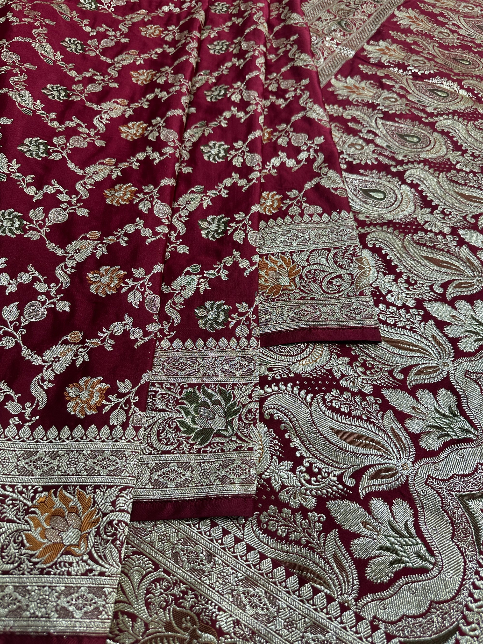 Beautifully draped maroon Banarasi bridal saree for wedding ceremonies

