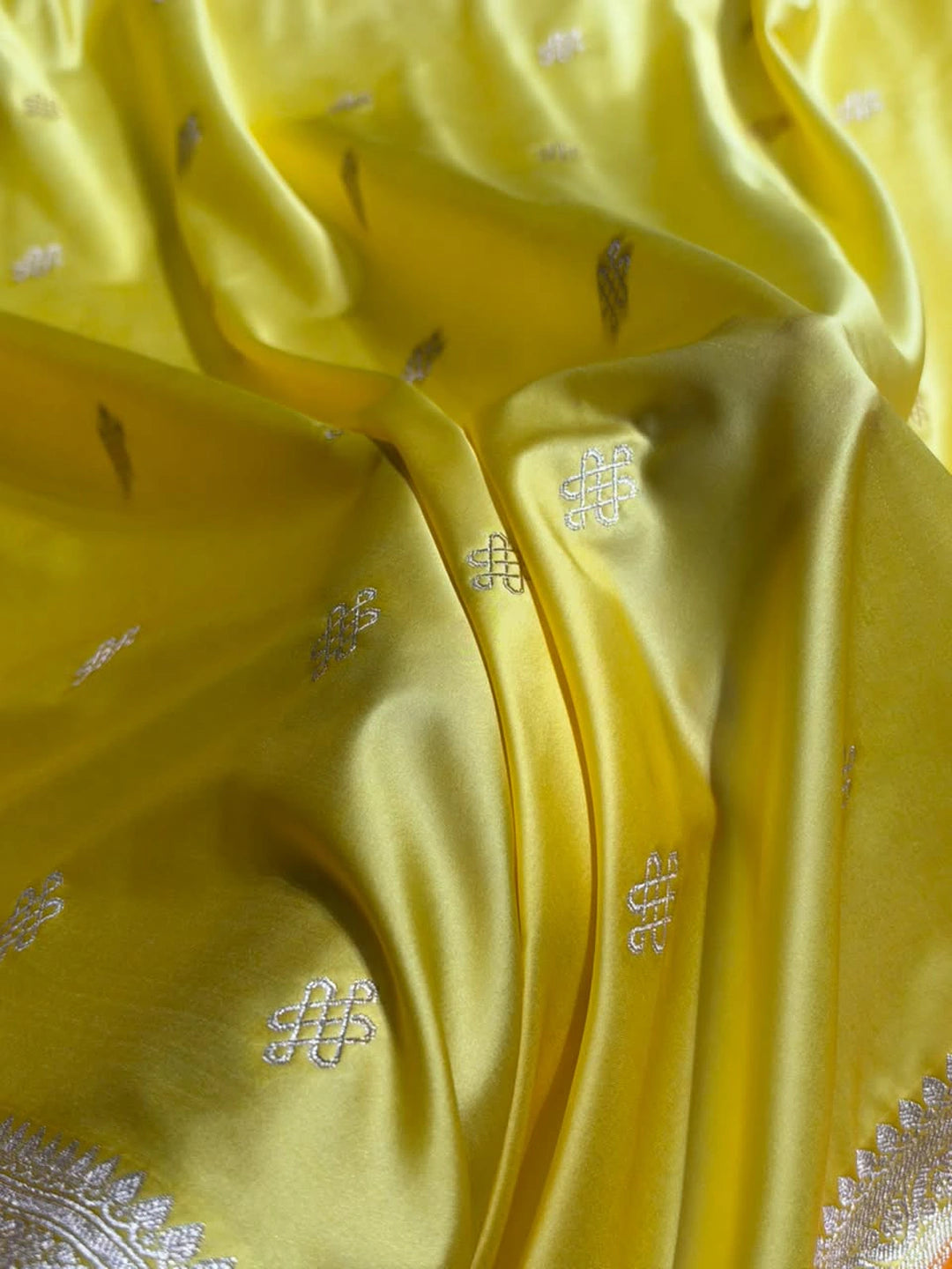 Yellow Mashru silk Banarasi saree with floral booti motifs and contrasting orange-toned floral border - Katan Banaras